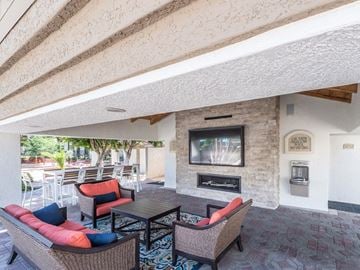 Chandler apartment for rent - a living room with a fireplace and a table and chairs