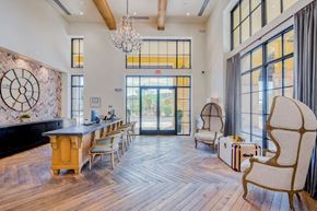 Scottsdale apartment for rent - a dining room with a long table and chairs and large windows