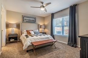 Ankeny apartment for rent - a bedroom with a bed and a ceiling fan