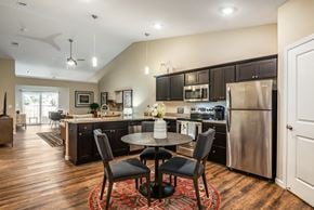 Ankeny apartment for rent - a kitchen and dining area with stainless steel appliances and a table