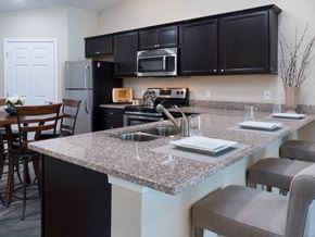 Avon apartment for rent - a kitchen with granite counter tops and a large island with a sink