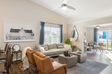 Batavia apartment for rent - a living room with a couch and chairs and a dining room table