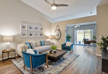Medina apartment for rent - an open living room with a couch and chairs and a ceiling fan