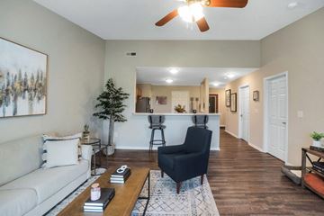Oregon apartment for rent - the living room and kitchen of an apartment with a couch and a chair