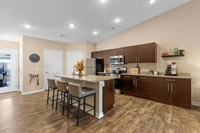 Altoona apartment for rent - A kitchen with brown cabinets and a white island.