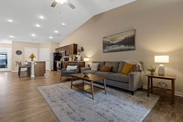 Altoona apartment for rent - A living room with a grey couch, a coffee table, and a painting on the wall.