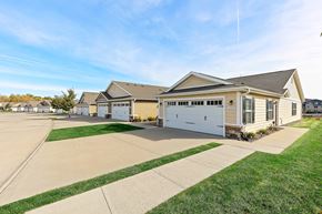 Ankeny apartment for rent - A row of houses with garages and driveways.