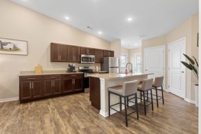 Ankeny apartment for rent - A kitchen with brown cabinets and a white island.