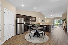Aurora apartment for rent - A modern kitchen with a dining table set for four.