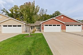 Battle Creek apartment for rent - A house with a red roof and two garages.