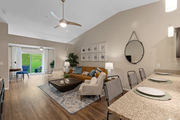 Battle Creek apartment for rent - A living room with a blue rug and a brown coffee table.