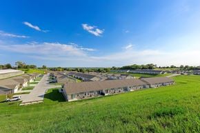 Bellevue apartment for rent - A row of houses with a grassy field in front.