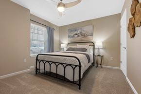 Bellevue apartment for rent - A bedroom with a large bed and a ceiling fan.