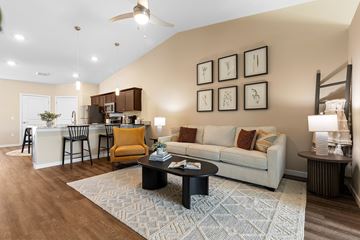 Bennington apartment for rent - A living room with a white couch and a rug on the floor.