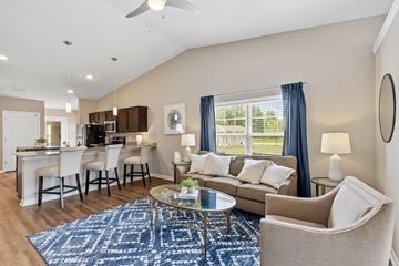 Blacklick apartment for rent - A living room with a blue rug and a glass coffee table.