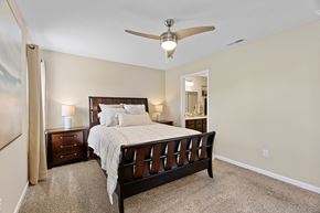Blacklick apartment for rent - A bedroom with a large bed and a ceiling fan.