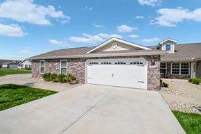 Brownsburg apartment for rent - A house with a white garage door and a stone wall.