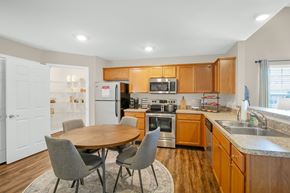 Brownsburg apartment for rent - A kitchen with a table and chairs in front of it.