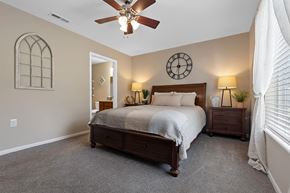 Brownstown apartment for rent - A bedroom with a bed, nightstands, and a ceiling fan.