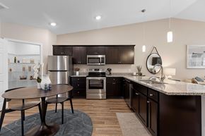 Brownstown Twp apartment for rent - A modern kitchen with dark brown cabinets and stainless steel appliances.