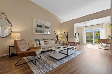 Brownstown Twp apartment for rent - A living room with a brown leather chair and a glass coffee table.