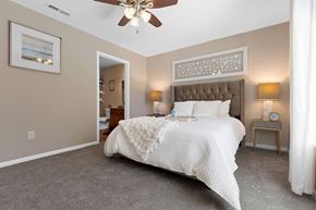 Brownstown apartment for rent - A bedroom with a large bed and a ceiling fan.