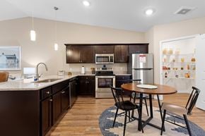 Burlington apartment for rent - A kitchen with a table and chairs in the middle of the room.