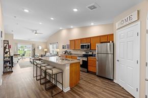 Canal Winchester apartment for rent - A kitchen with a white refrigerator and wooden cabinets.