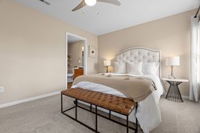 Canal Winchester apartment for rent - A bedroom with a large bed and a ceiling fan.