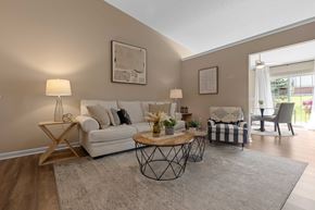 Dayton apartment for rent - A living room with a white sofa, a coffee table, and a chair.