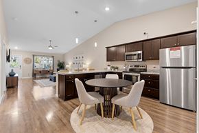 Charlotte apartment for rent - A modern kitchen with a large island and a dining table set for four.