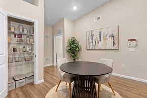 Charlotte apartment for rent - A dining room with a table and chairs and a potted plant.