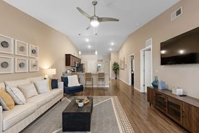 Charlotte apartment for rent - A living room with a white couch and a ceiling fan.