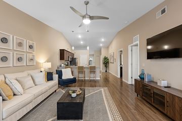 Charlotte apartment for rent - A living room with a white couch and a ceiling fan.