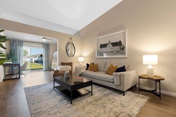 Chesterfield apartment for rent - A living room with a white couch, a coffee table, and a painting on the wall.