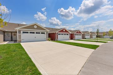 Cincinnati apartment for rent - A row of houses with garages and driveways.
