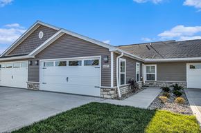 Kalamazoo apartment for rent - A two-story house with a garage and a driveway.
