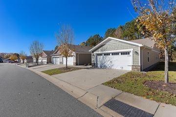 Concord apartment for rent - A residential street with houses on both sides and a tree with yellow leaves.
