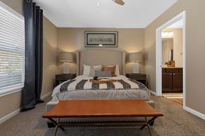Concord apartment for rent - A bedroom with a bed, two lamps, and a picture on the wall.