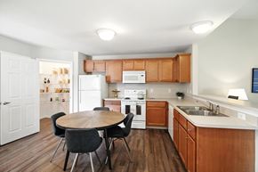 Danville apartment for rent - A kitchen with a table and chairs in the middle of the room.