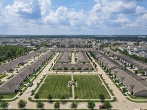 Dublin apartment for rent - A large suburban housing development with a central green space and a road running through it.