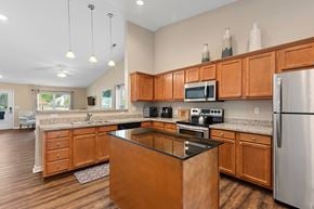 Dublin apartment for rent - A kitchen with wooden cabinets and a black island.