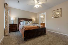 Dublin apartment for rent - A bedroom with a large bed, a dresser, and a ceiling fan.
