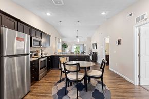 Fairborn apartment for rent - A kitchen with a table and chairs in the middle of the room.