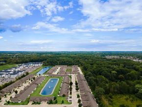 Fort Wayne apartment for rent - A bird's eye view of a residential area with a swimming pool and apartment buildings.