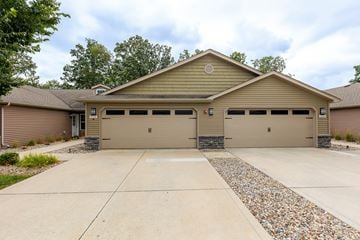 Fort Wayne apartment for rent - A two-car garage with a stone border in front.