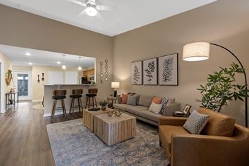 Fort Wayne apartment for rent - A living room with a brown couch and a blue rug.
