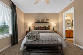 Fort Wayne apartment for rent - A bedroom with a large bed and a ceiling fan.