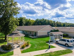 Fort Wayne apartment for rent - A car is parked in front of a house with a gazebo in the front yard.