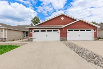 Fort Wayne apartment for rent - A red garage with white doors is situated in front of a house.